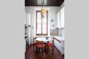 a kitchen with a table and chairs and a window at Loft in pieno Centro Storico in Como