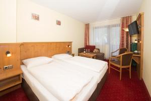 Postel nebo postele na pokoji v ubytování Alpen-Hotel Seimler