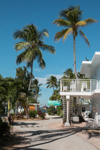 a building with a balcony and palm trees at La Jolla Resort in Islamorada