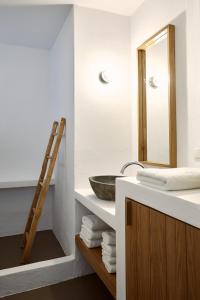 a bathroom with a sink and a mirror at Acron Villas in Kolympithres