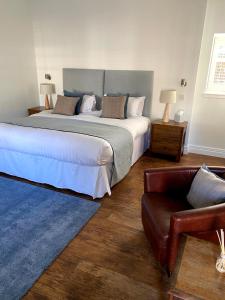 a bedroom with a large bed and a couch at Shieldhill Castle in Libberton