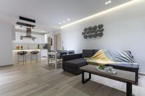 a living room with a couch and a table at Executive Rhodes Villa Villa Faros Private Pool 3 Bedrooms Lindos in Líndos