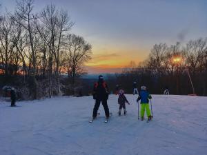 a group of people on skis in the snow at sunset at Shawnee Inn and Golf Resort in East Stroudsburg