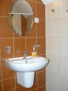 a bathroom with a white sink and a mirror at Guesthouse Geto in Belogradchik