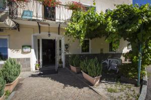 a house with a courtyard with plants in front of it at Albergo Stella in Cavalese