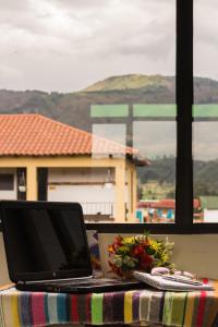 a laptop computer sitting on a table in front of a window at Hotel Villa Sofia in Nobsa