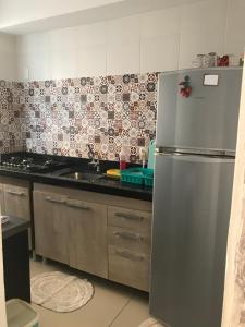 a kitchen with a stainless steel refrigerator in it at APTO ACONCHEGANTE 1KM DA Praia do aracagy e 4KM DA Litorânea in São Luís