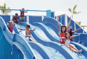a group of children on a water slide at a water park at Riu Playa Blanca - All Inclusive in Playa Blanca