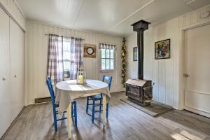 a dining room with a table and chairs and a stove at Homey Horse Farm Hideaway about 6 Mi to KY Horse Park! in Lexington