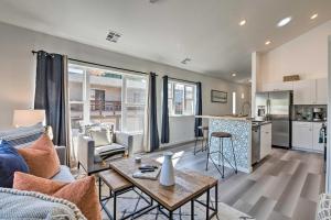 a living room with a couch and a table at Modern Midtown Reno Retreat Ski, Hike and Bike! in Reno