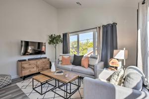 a living room with a couch and a table at Modern Midtown Reno Retreat Ski, Hike and Bike! in Reno