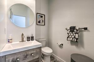 a bathroom with a sink and a toilet and a mirror at Modern Midtown Haven with Garage Mt Rose Day Trips! in Reno +20 photos