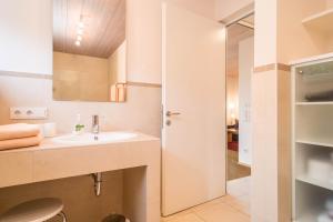 a bathroom with a sink and a shower at Rosenblüte in Lindau +14 photos