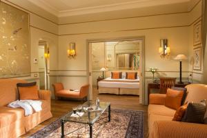 a living room filled with furniture and a large window at Hotel Degli Aranci in Rome