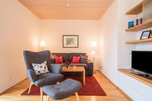 a living room with a couch and a table at Rosenblüte in Lindau