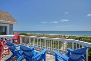 a deck with chairs and a table and the ocean at Sand Goodies PI128 in Corolla