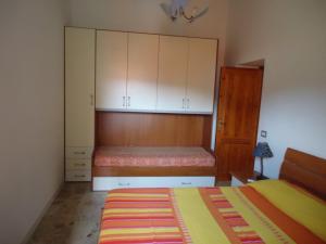 a bedroom with a bed and white cabinets at Appartamento Margot in Lipari