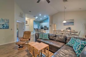 a living room with a leather couch and a table at Breezy Gulf Coast Getaway about 4 Mi to Beach Park in Port Charlotte