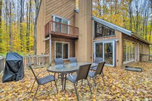 a house with a table and chairs in the yard at Family Escape - Near Little Traverse Wheelway in Harbor Springs