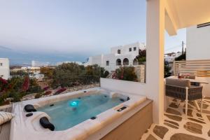 a hot tub on the balcony of a house at Kandiani Bleu Ciel in Naousa