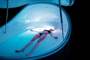 a woman in a glass tunnel with a woman in it at Carillon Miami Wellness Resort in Miami Beach