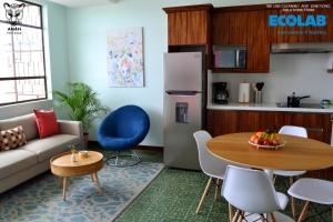 a living room with a couch and a table at Apartamentos el Prado en Zona 1 - ANAH hotel group in Guatemala