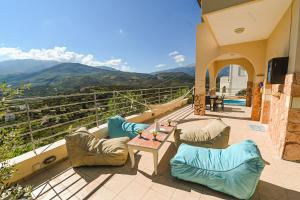 a patio with couches and a table with a view at Aloe Villa Chania Crete in Georgioupolis