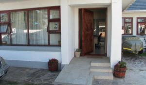 uma porta da frente de uma casa com um carro fora em Bonani B & B na Cidade do Cabo