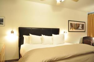 a bedroom with a large bed with a black headboard at Juniper Springs Lodge # 203 in Mammoth Lakes