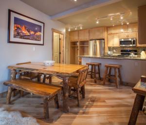 a kitchen with a wooden table and wooden chairs at Juniper Springs Lodge # 426 in Mammoth Lakes