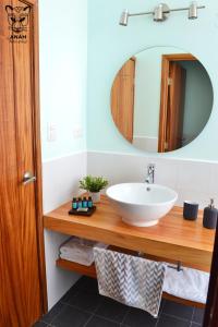 a bathroom with a sink and a mirror at Apartamentos el Prado en Zona 1 - ANAH hotel group in Guatemala