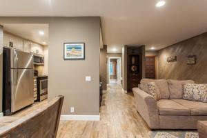 a living room with a couch and a kitchen at Snowcreek #405 - Phase III in Mammoth Lakes