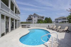 a swimming pool on a patio of a house at Jewel of the Deep VOH1 in Corolla