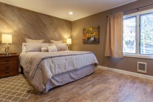 a bedroom with a large bed and a window at Snowcreek #405 - Phase III in Mammoth Lakes