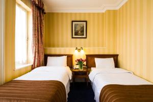 Ein Bett oder Betten in einem Zimmer der Unterkunft Best Western Swiss Cottage Hotel