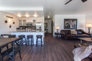 a kitchen and living room with a couch and a table at Village # 2230 - White Mountain Lodge in Mammoth Lakes