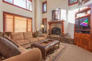 a living room with a couch and a fireplace at Timbers # 1033 in Mammoth Lakes