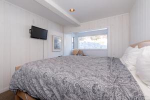 a bedroom with a bed and a tv on the wall at Chamonix # 62 in Mammoth Lakes +25 photos