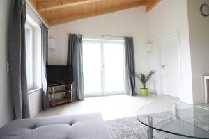 a living room with a couch and a glass table at Ferienwohnung Stocker in Seebruck