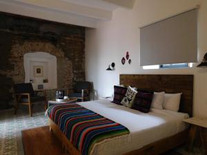a bedroom with a large bed in a room at Santa Josefita in Cholula