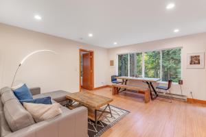 a living room with a couch and a table at McKinnis Hill Cabin in Eastsound