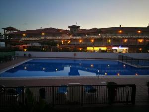 a large swimming pool in front of a building at PLAYA LAS VISTAS LOFT in Los Cristianos