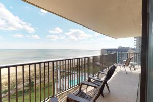 a balcony with two benches and a view of the ocean at Sea Colony Edgewater House in Bethany Beach