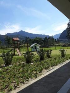 a park with a playground and a swing at Loft Aldeia dos Reis in Mangaratiba