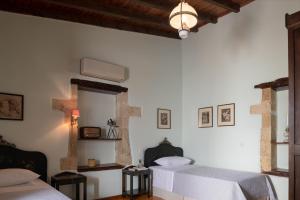 A bed or beds in a room at The Quintessential Cretan Villa