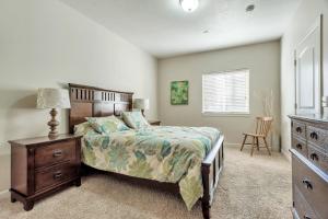 a bedroom with a bed and a dresser and a window at Downtown Condo Near Convention Center (Disability Access) in Salt Lake City