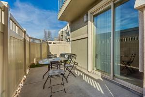 a patio with a table and chairs on a balcony at Downtown Condo Near Convention Center (Disability Access) in Salt Lake City