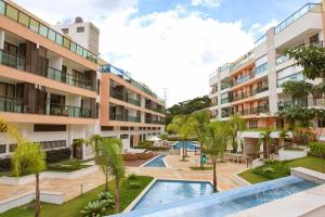 an image of an apartment complex with a swimming pool at Belíssimo Apartamento Centro de Itaipava All Suites in Itaipava