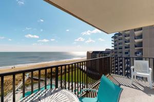 a balcony with chairs and a view of the beach at Sea Colony Edgewater House in Bethany Beach +1 photo