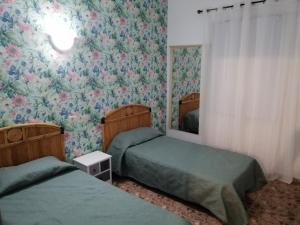 A bed or beds in a room at Alcaravaneras Hostel